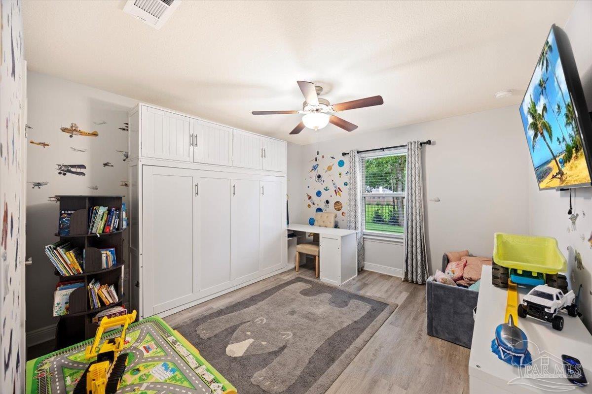 7191 Apples Way Navarre, FL 32566 - Photo 44 of 54 a living room with furniture and a book shelf