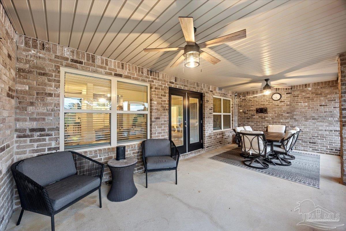 7191 Apples Way Navarre, FL 32566 - Photo 48 of 54 a living room with furniture and a large window