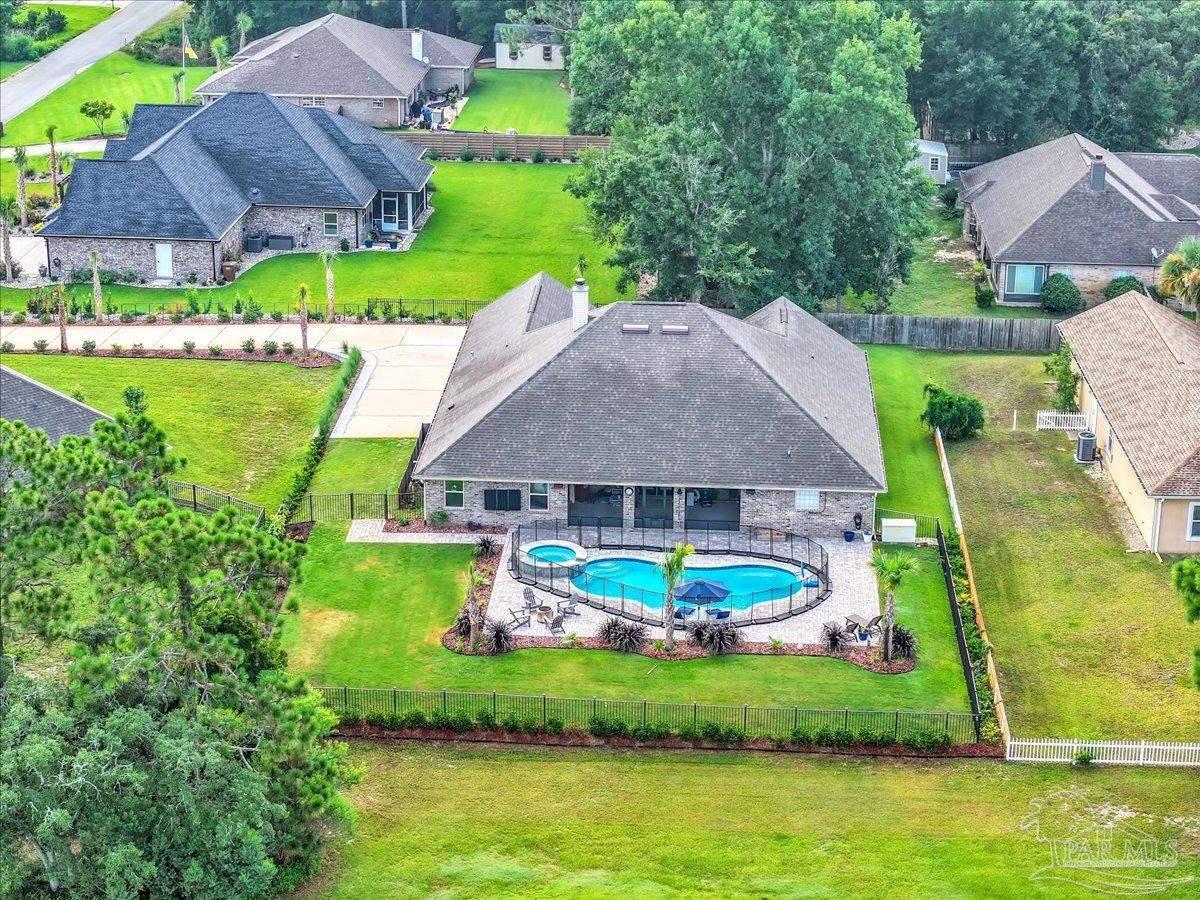 7191 Apples Way Navarre, FL 32566 - Photo 50 of 54 an aerial view of a house with a garden and swimming pool