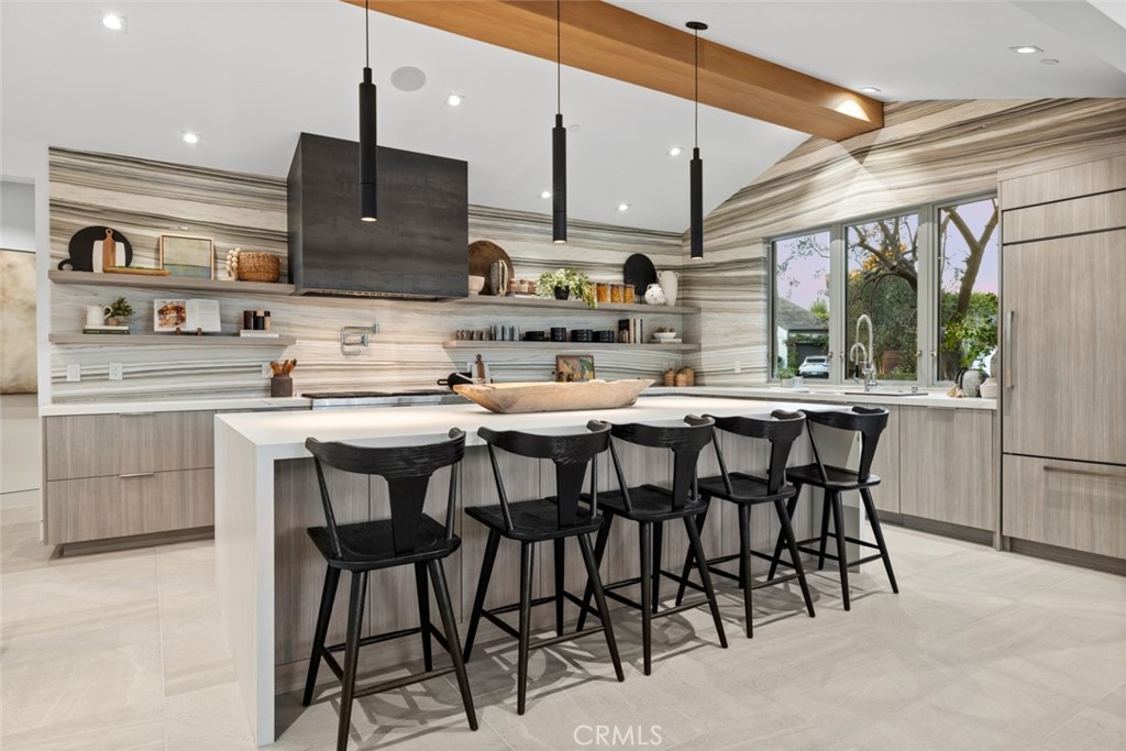 1399 Galaxy Drive Newport Beach, CA 92660 - Photo 8 of 39 a kitchen with stainless steel appliances kitchen island granite countertop a table chairs sink and cabinets