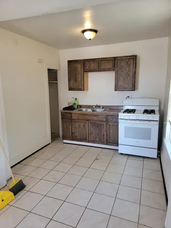 a kitchen with stainless steel appliances a sink stove and cabinets