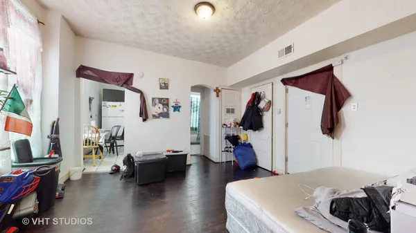 a bedroom with furniture and a flat screen tv