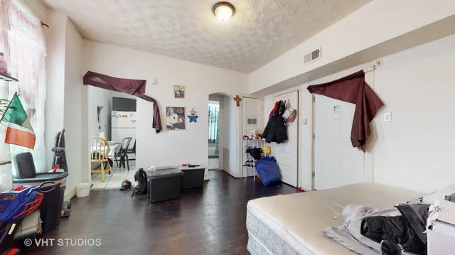a bedroom with furniture and a flat screen tv