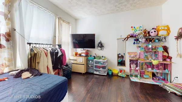 a bedroom with bed and a tv