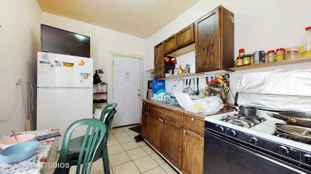 a kitchen with stainless steel appliances granite countertop a refrigerator and a stove