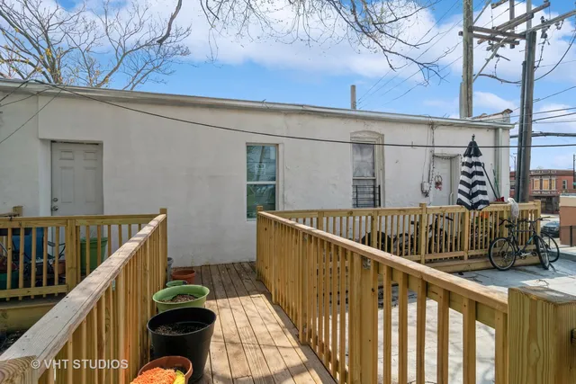 a view of balcony with wooden floor and fence