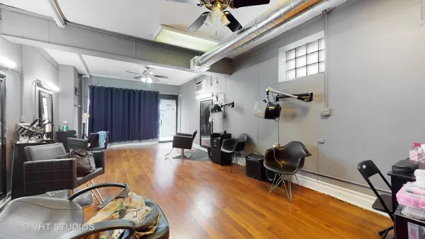 a view of a workspace with furniture and gym equipment