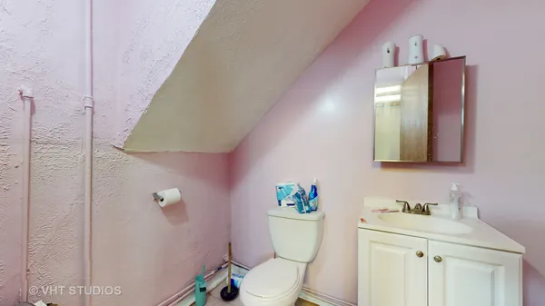 a bathroom with a toilet sink and mirror