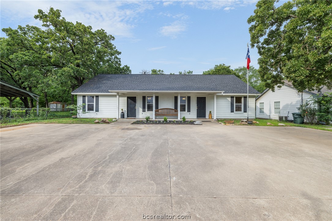 2287 North Earl Rudder Freeway Bryan, TX 77803 - Photo 1 of 32 a front view of a house with a yard