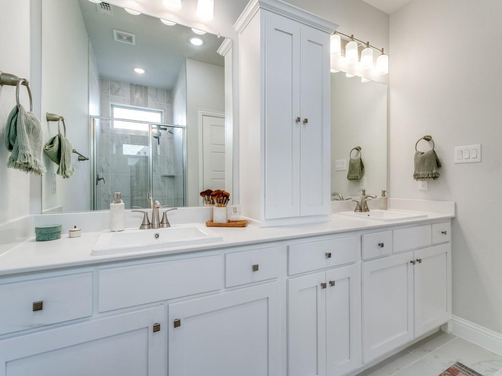 12964 Rockham Lane Dallas, TX 75234 - Photo 14 of 24 a bathroom with double sink and a mirror