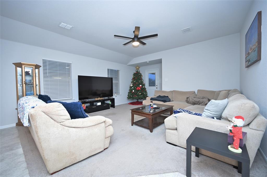 3713 Ridgeway Lane Argyle, TX 76226 - Photo 12 of 40 a living room with furniture and a flat screen tv