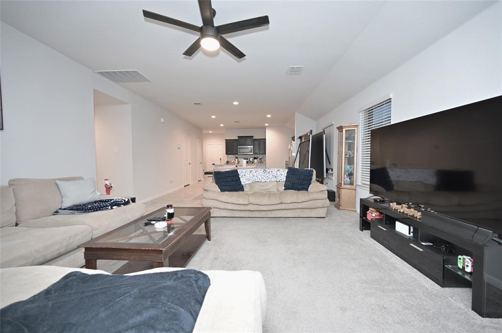 3713 Ridgeway Lane Argyle, TX 76226 - Photo 13 of 40 a living room with furniture and a flat screen tv