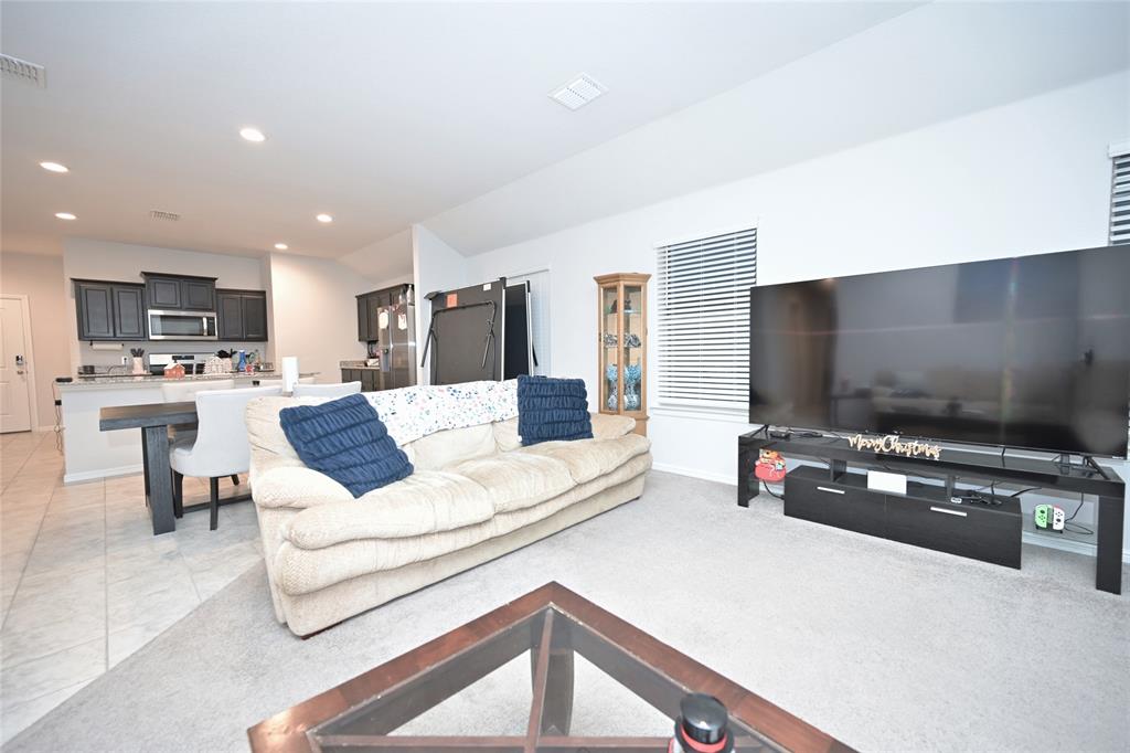 3713 Ridgeway Lane Argyle, TX 76226 - Photo 16 of 40 a living room with furniture and a flat screen tv