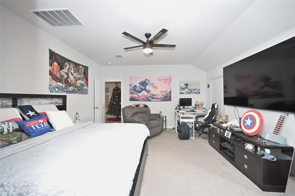 3713 Ridgeway Lane Argyle, TX 76226 - Photo 19 of 40 a bedroom with furniture and a flat screen tv