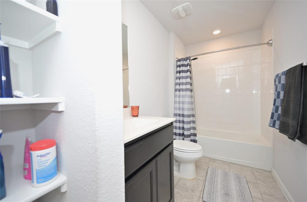 3713 Ridgeway Lane Argyle, TX 76226 - Photo 24 of 40 a bathroom with a sink a toilet and shower