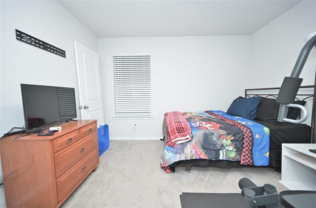 3713 Ridgeway Lane Argyle, TX 76226 - Photo 25 of 40 a bedroom with a bed and a computer on the desk