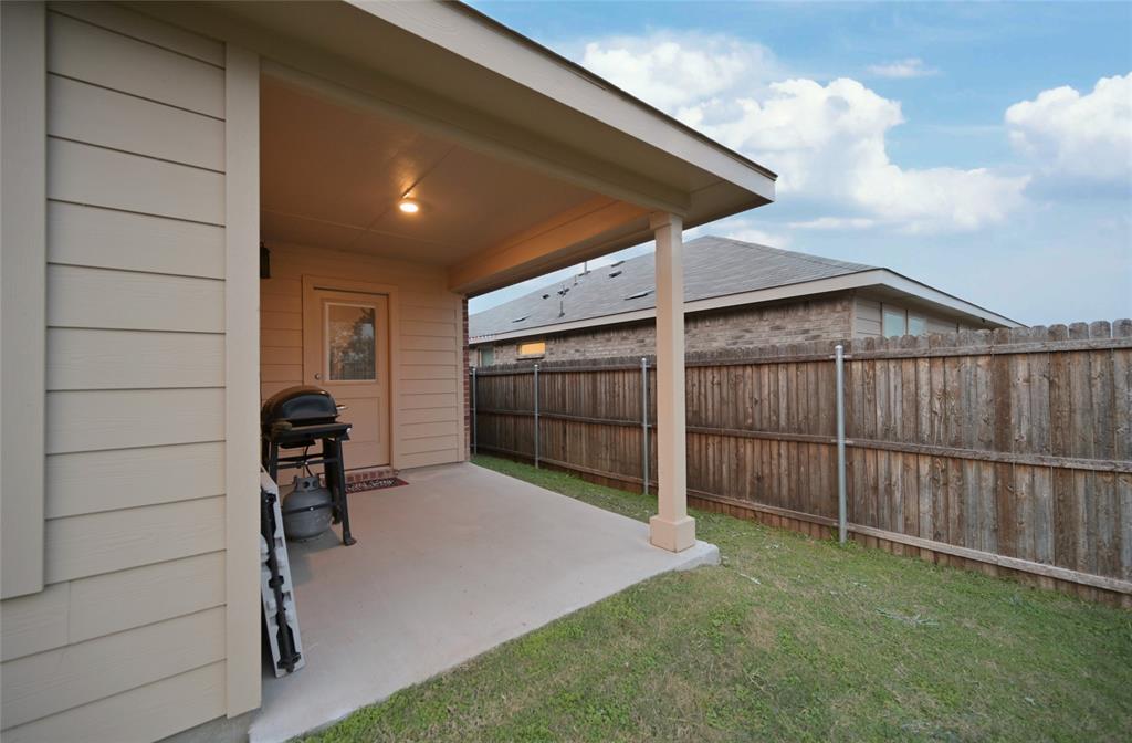 3713 Ridgeway Lane Argyle, TX 76226 - Photo 32 of 40 a view of backyard with wooden fence and a large window