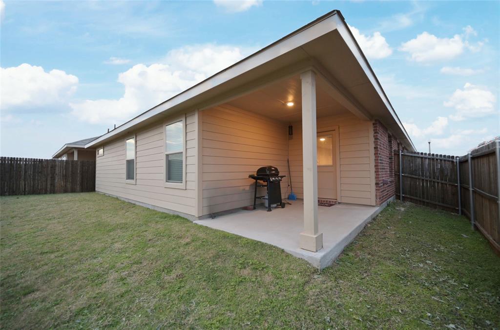 3713 Ridgeway Lane Argyle, TX 76226 - Photo 33 of 40 a backyard of a house with table and chairs