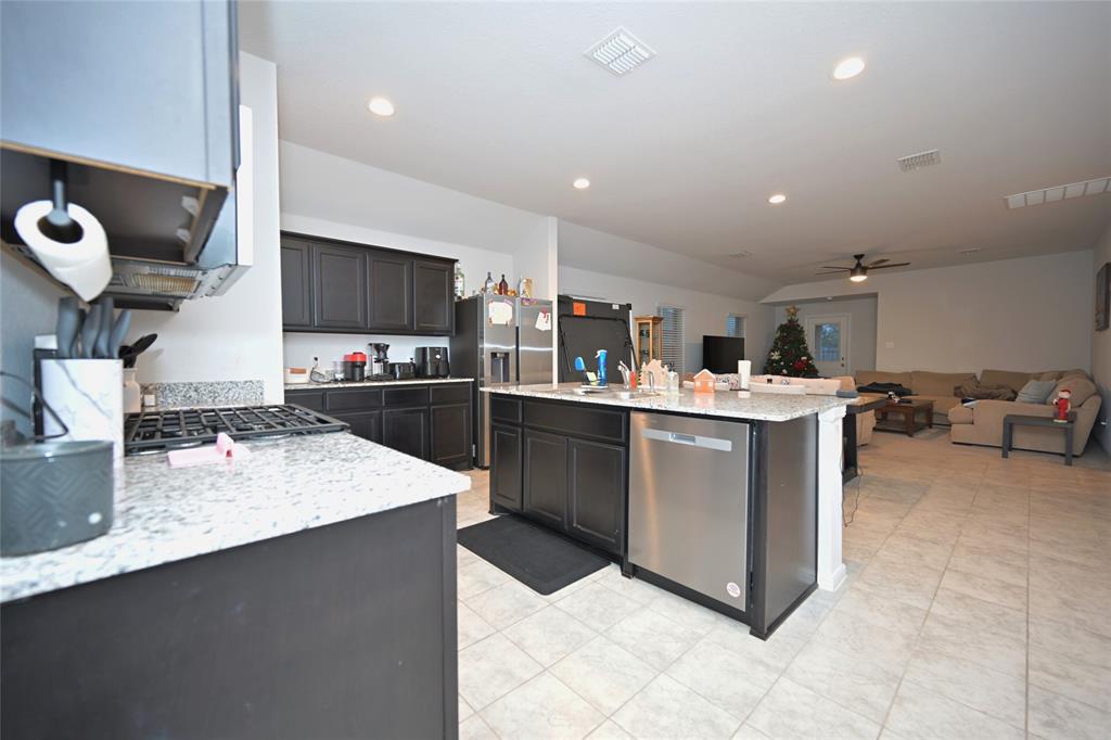 3713 Ridgeway Lane Argyle, TX 76226 - Photo 6 of 40 a kitchen with kitchen island stainless steel appliances a sink a counter top space appliances and cabinets