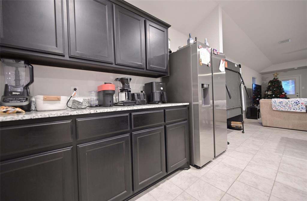 3713 Ridgeway Lane Argyle, TX 76226 - Photo 8 of 40 a kitchen with refrigerator and cabinets