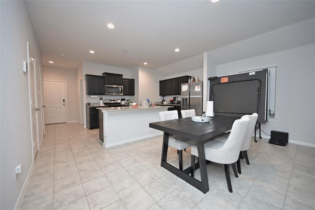 3713 Ridgeway Lane Argyle, TX 76226 - Photo 9 of 40 a kitchen with a sink cabinets and stainless steel appliances
