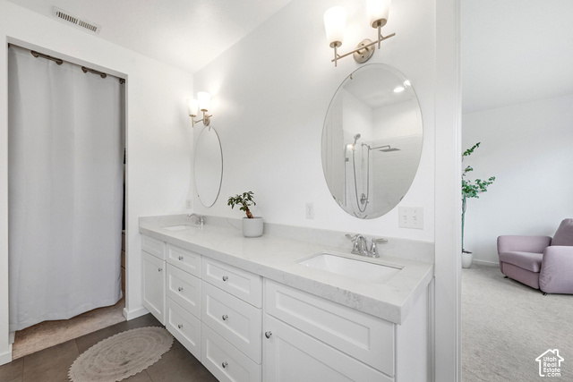 1295 North Canyon View Road Midway, UT 84049 - Photo 25 of 52 Dual vanity with white cabinetry and integrated sinks, oval mirrors, and wall-mounted light fixtures