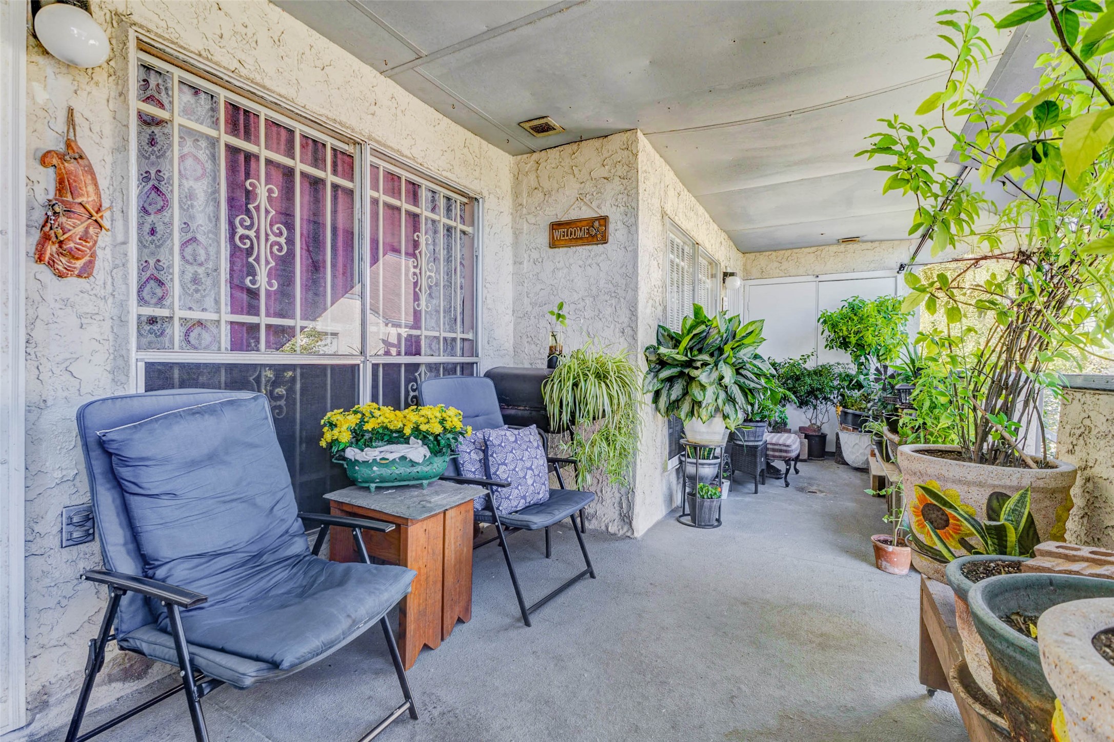 a dining room with furniture and a potted plant
