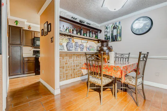 a view of a dining room with furniture and a kitchen view