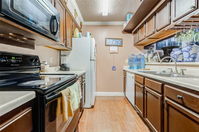 a kitchen with stainless steel appliances granite countertop a stove and a sink