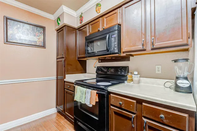a kitchen with granite countertop a stove and a microwave