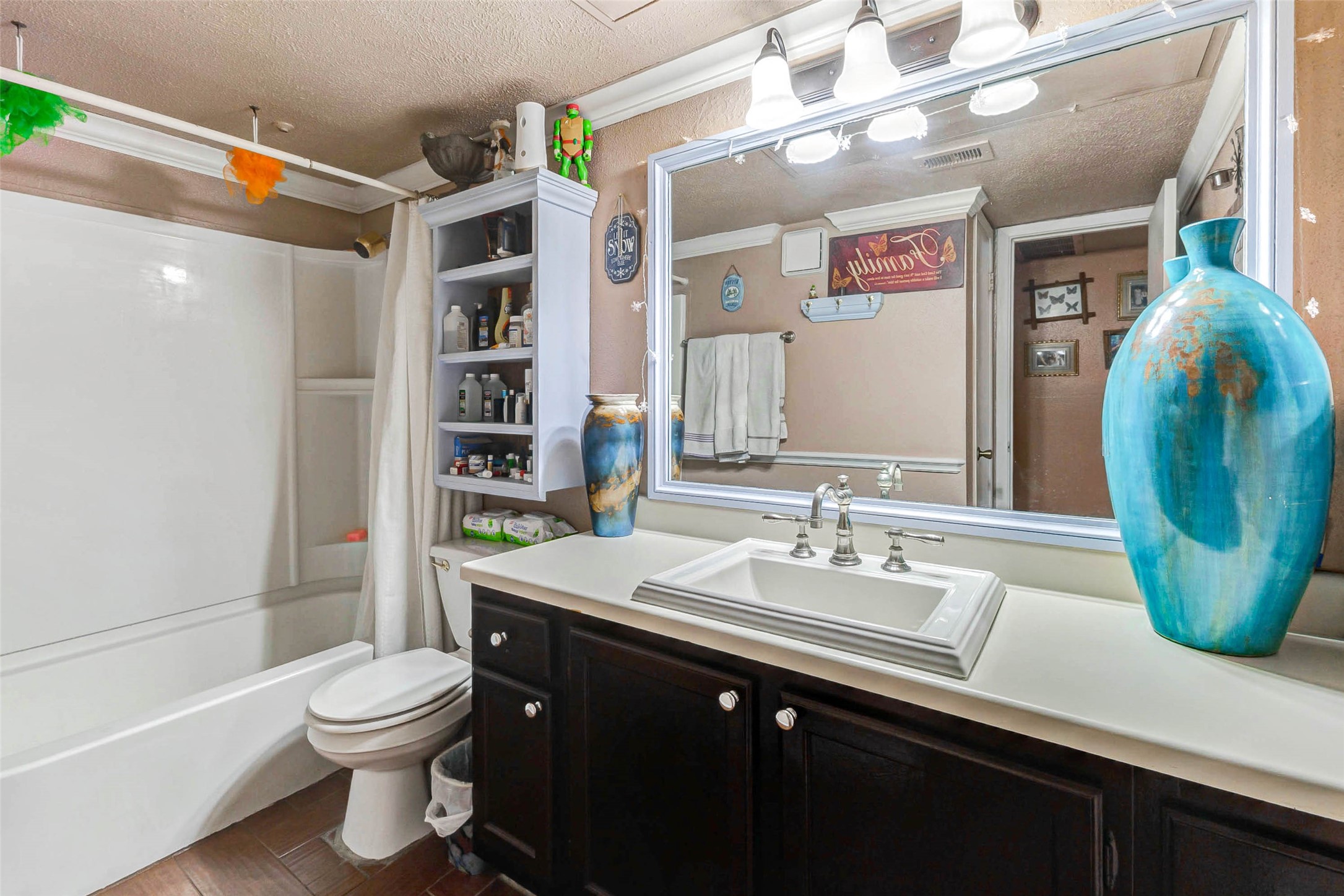 7313 Gulf Freeway, Unit 1011 Houston, TX 77017 - Photo 9 of 11 a bathroom with a sink a toilet and shower