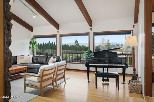 a dining room with furniture a chandelier and wooden floor
