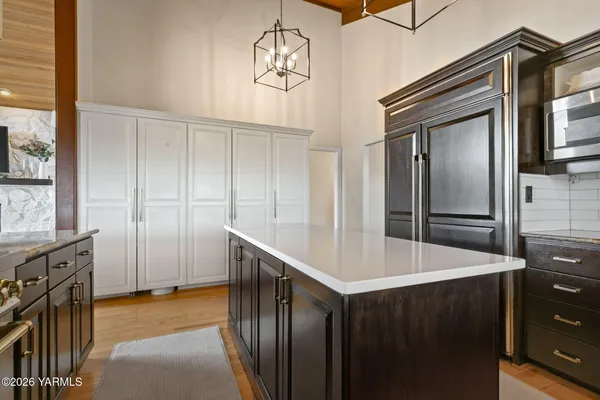 a spacious bedroom with bed and wooden floor