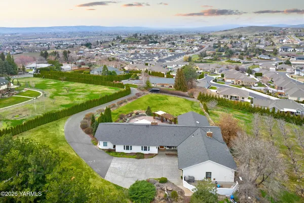 a view of a house with a backyard and a patio