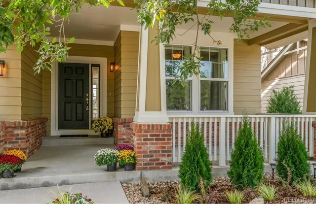 a view of a house with a window and flower garden
