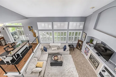 a living room with furniture and a floor to ceiling window
