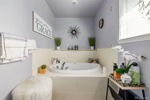 a bath room with a sink and a mirror