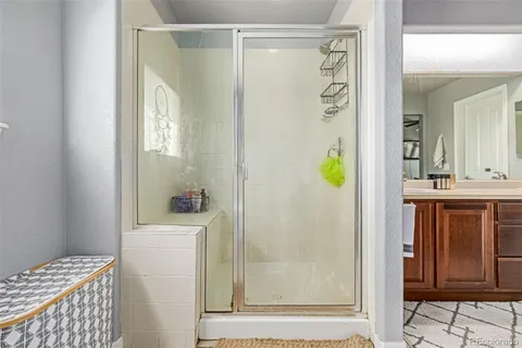 a bathroom with a shower a mirror and a sink