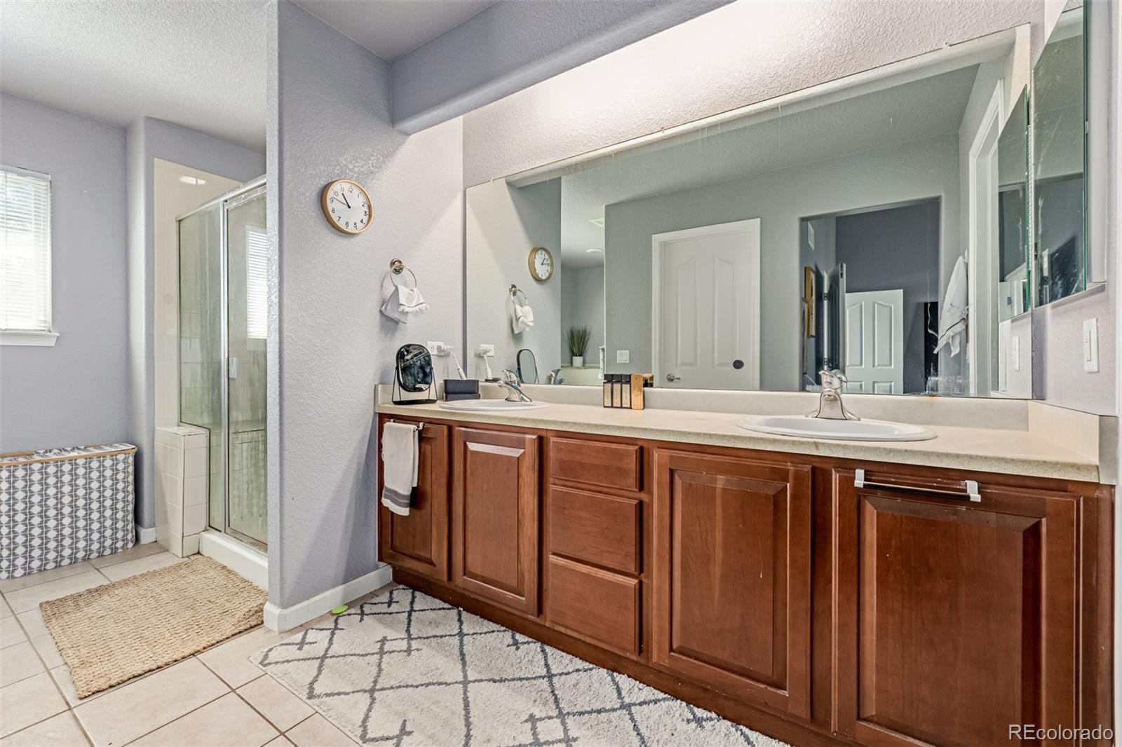 24248 East Roxbury Circle Aurora, CO 80016 - Photo 16 of 42 a spacious bathroom with a double vanity sink mirror and