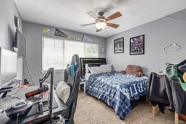 a bedroom with a bed window and a desk