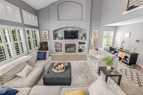 a living room with furniture fireplace and a flat screen tv