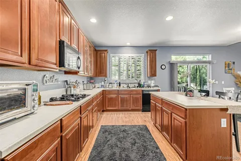 a kitchen with stainless steel appliances a sink stove and cabinets
