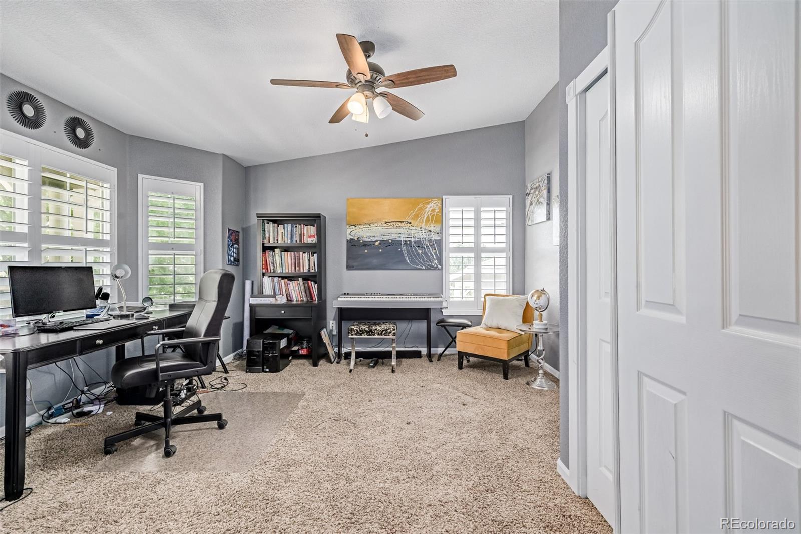 24248 East Roxbury Circle Aurora, CO 80016 - Photo 10 of 42 a living room with furniture and a flat screen tv