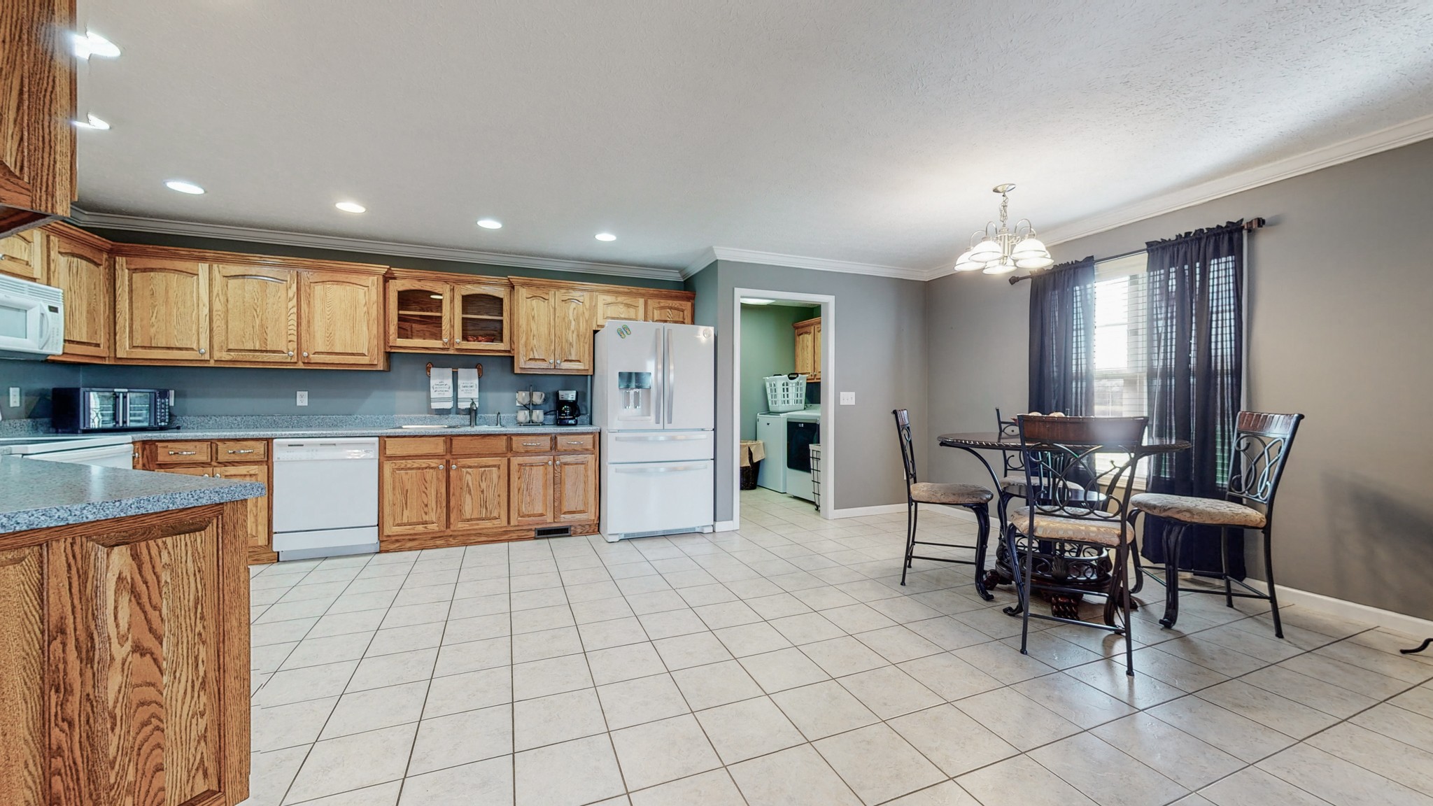3608 Gnat Hill Road Manchester, TN 37355 - Photo 5 of 23 a kitchen with stainless steel appliances kitchen island granite countertop a stove a sink a dining table and chairs