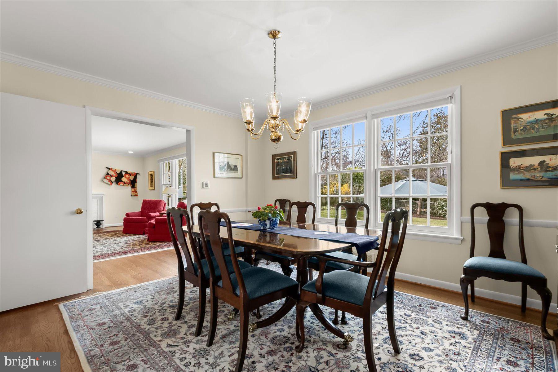 4716 Merivale Road Chevy Chase, MD 20815 - Photo 11 of 48 a dining room with furniture a rug and a chandelier