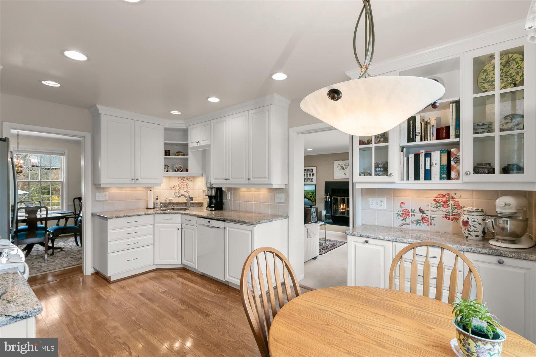 4716 Merivale Road Chevy Chase, MD 20815 - Photo 12 of 48 a kitchen with stainless steel appliances granite countertop a stove a sink a dining table and chairs
