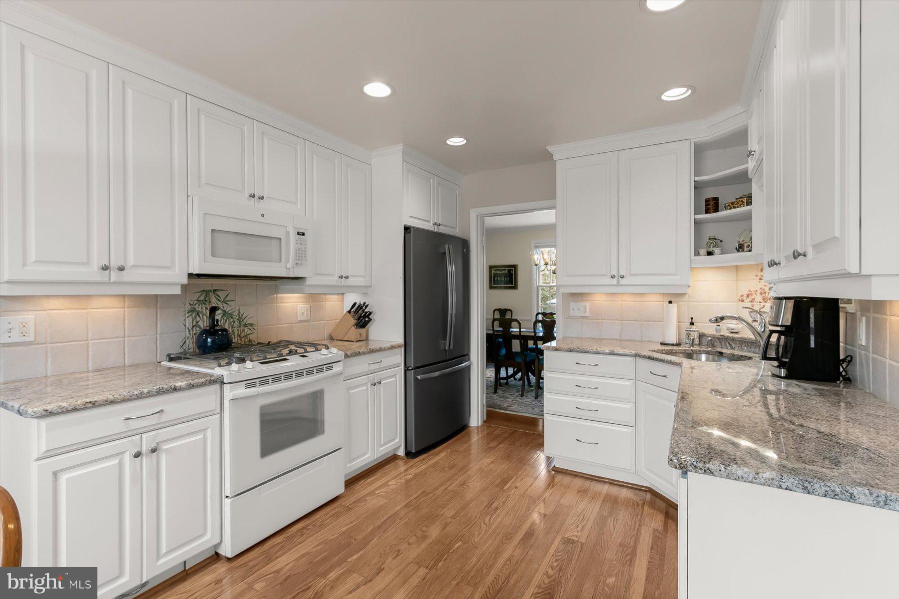 4716 Merivale Road Chevy Chase, MD 20815 - Photo 13 of 48 a kitchen with a stove a sink and a refrigerator
