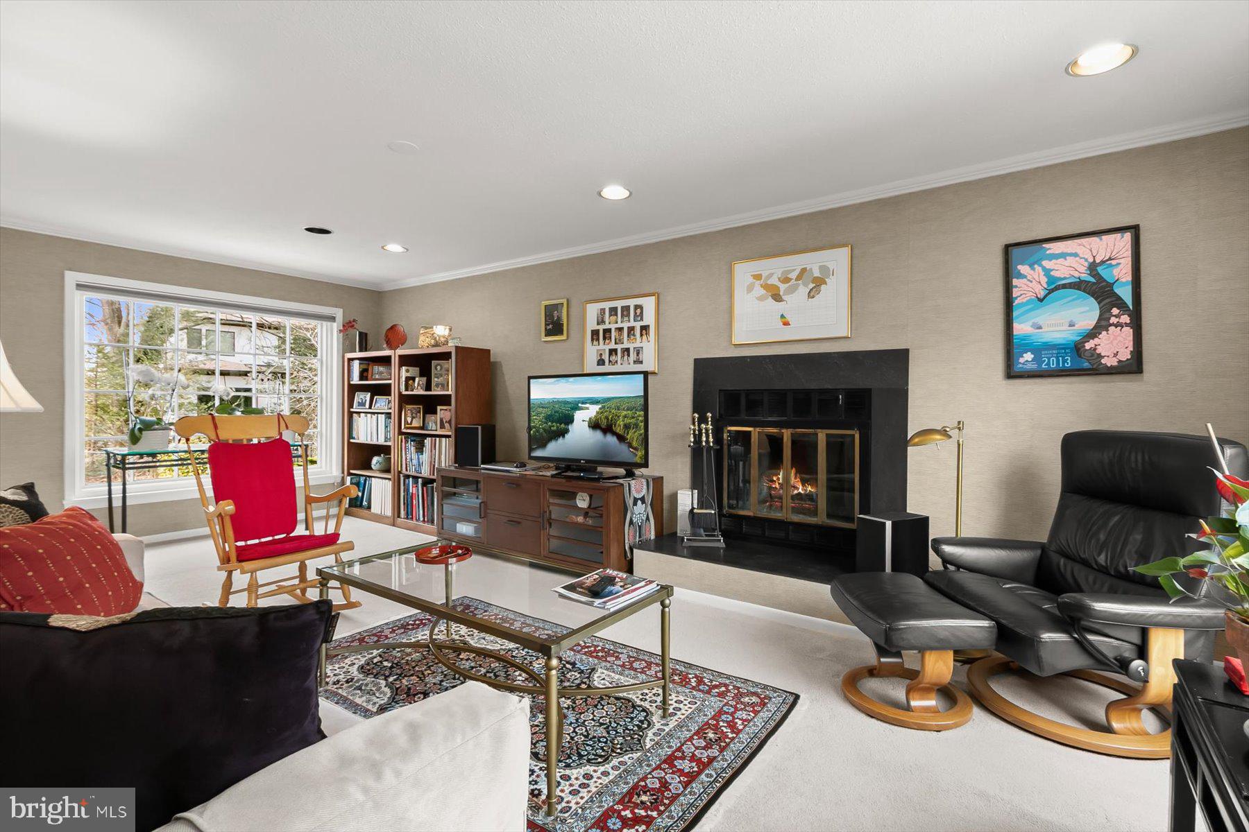 4716 Merivale Road Chevy Chase, MD 20815 - Photo 17 of 48 a living room with furniture a fireplace and a flat screen tv