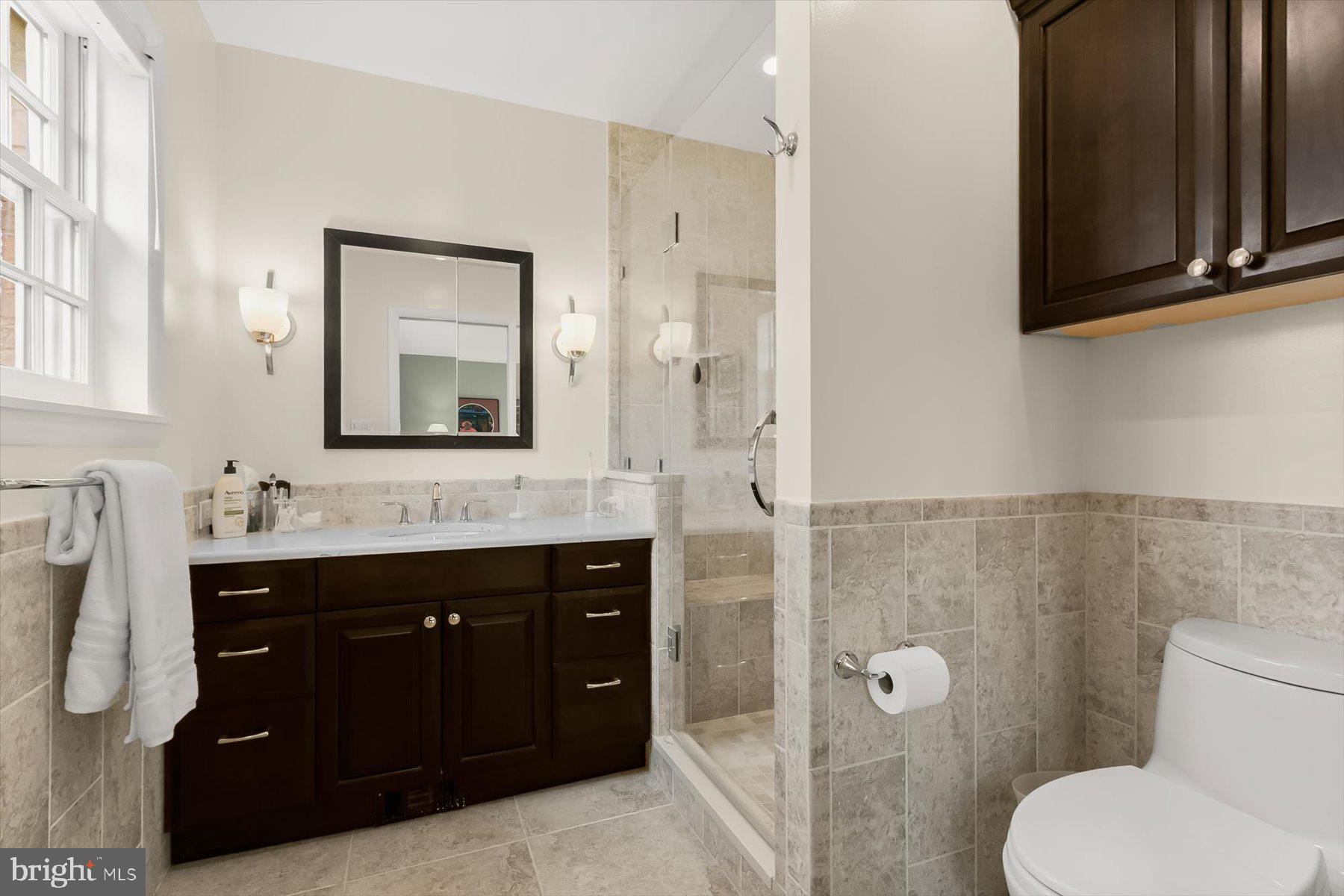 4716 Merivale Road Chevy Chase, MD 20815 - Photo 27 of 48 a bathroom with a toilet sink and mirror