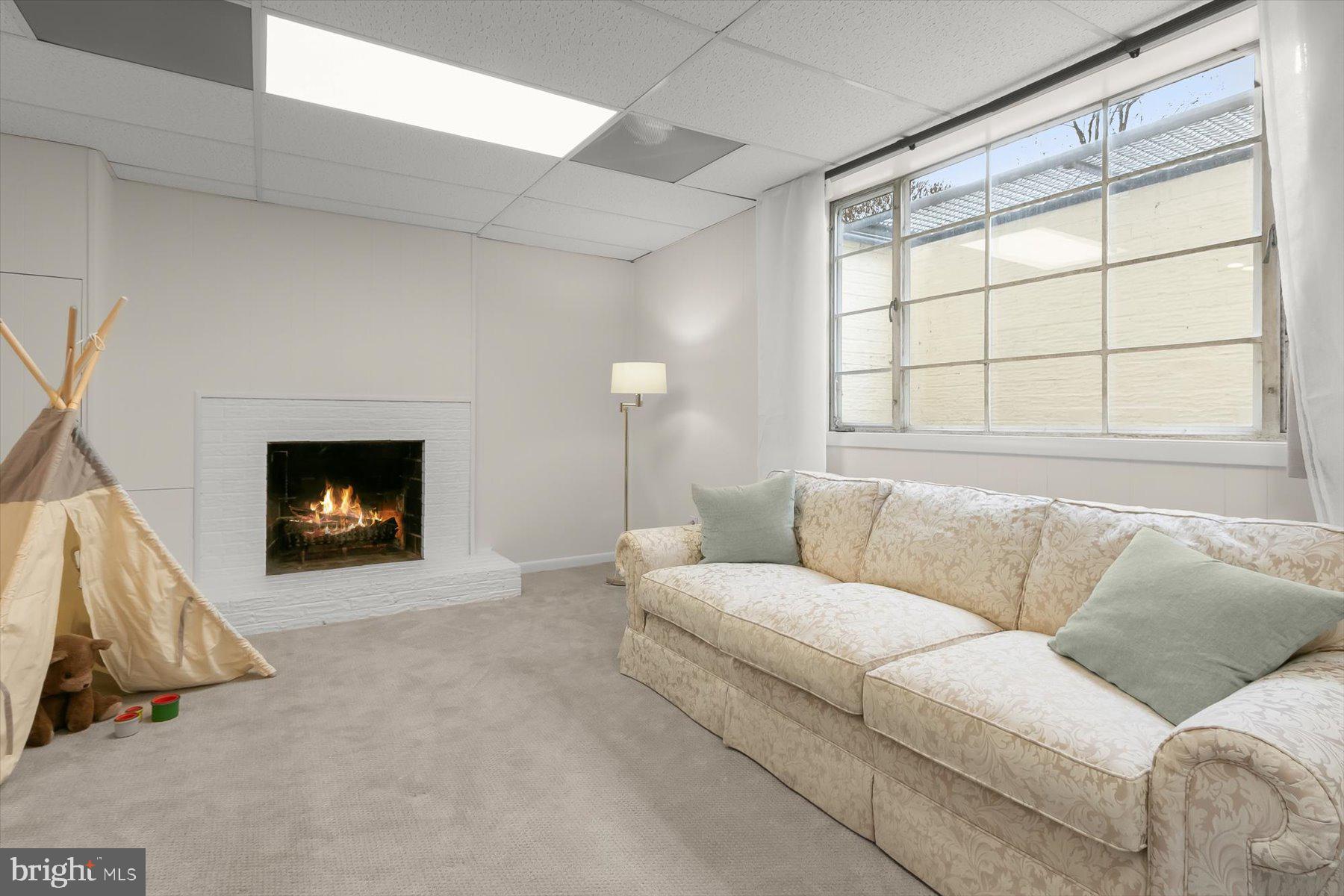 4716 Merivale Road Chevy Chase, MD 20815 - Photo 36 of 48 a living room with furniture and a fireplace